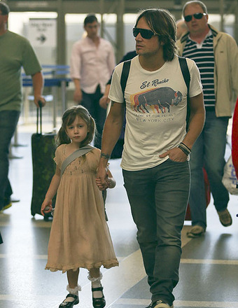 Keith Urban held hands with daughter Sunday Rose as they departed from LAX.