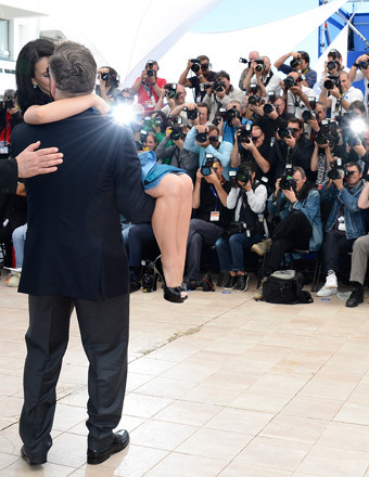 Alec Baldwin swept wife Hilaria off her feet at the Cannes "Seduced and Abandoned" photo call.