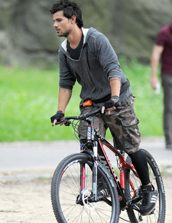 Taylor Lautner rode a bicycle on the set of "Tracers" in Central Park on Wednesday.