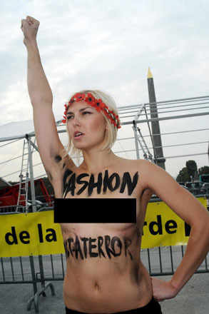 Video! British Model Punches Topless Protester on Catwalk