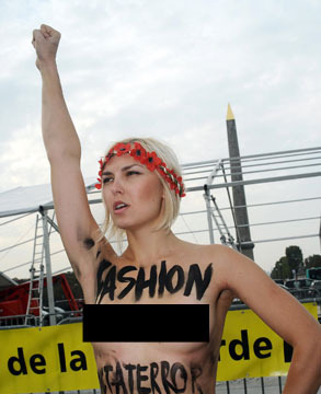 Video! British Model Punches Topless Protester on Catwalk