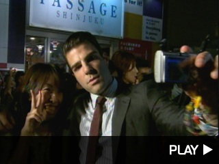 Zachary Quinto takes a picture with a fan.
