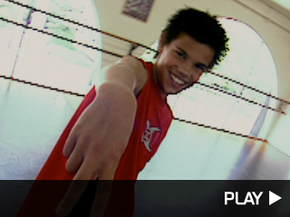 Taylor Lautner gives a peace sign.