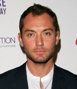 Jude Law whacked a female photographer on the noggin in London on Wednesday night.